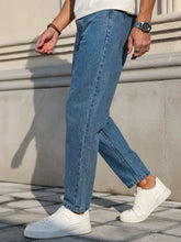 Load image into Gallery viewer, Men's Jeans Are Made of Classic Blue Denim Fabric with a Loose Fit, Making Them an Indispensable Versatile Item in the Wardrobe.
