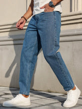 Load image into Gallery viewer, Men's Jeans Are Made of Classic Blue Denim Fabric with a Loose Fit, Making Them an Indispensable Versatile Item in the Wardrobe.
