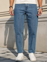 Load image into Gallery viewer, Men's Jeans Are Made of Classic Blue Denim Fabric with a Loose Fit, Making Them an Indispensable Versatile Item in the Wardrobe.
