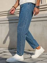 Load image into Gallery viewer, Men's Jeans Are Made of Classic Blue Denim Fabric with a Loose Fit, Making Them an Indispensable Versatile Item in the Wardrobe.

