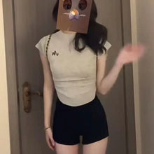 Load image into Gallery viewer, Black shorts for women in summer, with a full crotch and low waist to show off weight and long legs. Wearing them externally, in
