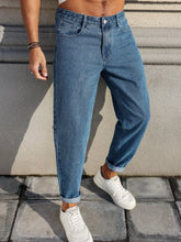 Load image into Gallery viewer, Men's Jeans Are Made of Classic Blue Denim Fabric with a Loose Fit, Making Them an Indispensable Versatile Item in the Wardrobe.

